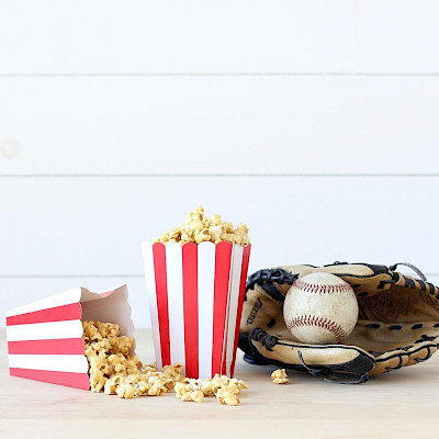 popcorn next to baseball glove for fundraiser