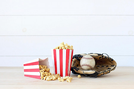 popcorn next to baseball glove for fundraiser